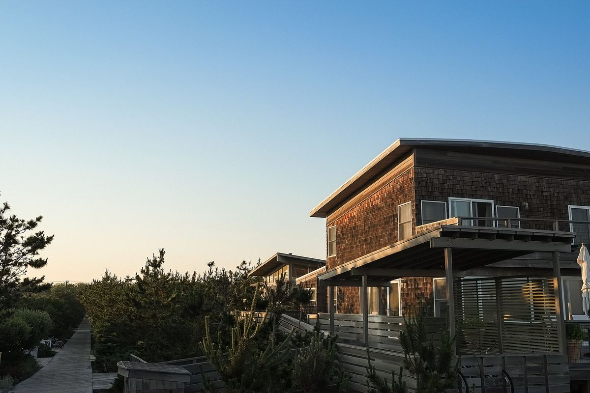 Wooden cottage with a balcony at sunset
