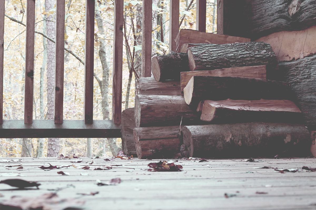 Firewood stacked on a wooden porch